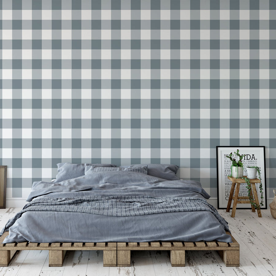 An urban style bedroom showing 'Faye' which is a grey gingham wallpaper featuring a classic checked plaid pattern with light slate grey squares on a white background in a repeating design.