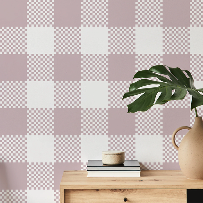 Rosie pink plaid wallpaper on a hallway wall with an oak console table and monstera